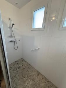 a white bathroom with a shower and a window at La ferme des Gabelles in Saint-Benoît-sur-Loire +46 photos