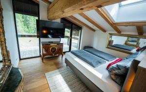 a bedroom with a bed and a flat screen tv at Panorama Quartier Seefeld in Seefeld in Tirol