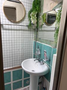 a bathroom with a sink and a mirror at Stay Everyday in Seoul +54 photos