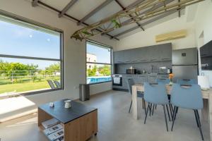 a kitchen and dining room with a table and chairs at Green Galini Villa Pelion - the small unit in Platanidia