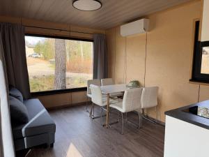 a dining room with a table and chairs and a window at SETO MAN Puhkekeskus in Värska