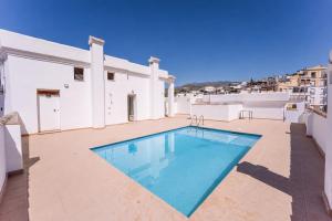 a swimming pool on the roof of a house at Rinconcito in Almuñécar