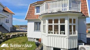 a tiny house with a balcony on top of it at Charming archipelago house in Grebbestad SE09082 in Grebbestad