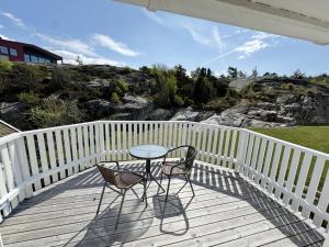 a table and two chairs on a wooden deck at Charming archipelago house in Grebbestad SE09082 in Grebbestad +15 photos