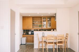 a kitchen and dining room with a table and chairs at Coucou House Gra in Toyooka