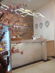 a counter in a store with a sign on the wall at De La Charis Hotel in Kediri +20 photos