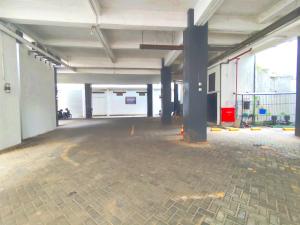 an empty parking lot with a parking garage at De La Charis Hotel in Kediri