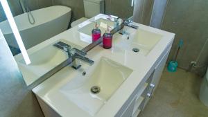 a bathroom with a white sink and a tub at Hillview Executive Self-Catering House in Blantyre +29 photos
