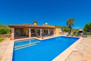 a swimming pool in front of a house at Ca na Margalida in Manacor