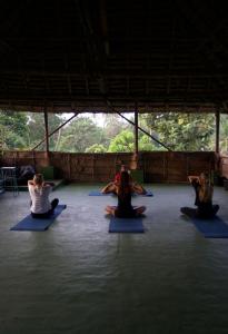 a group of people sitting in a yoga class at Paddle Cult Surf & Yoga in Varkala