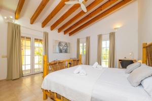 a bedroom with a large white bed with white pillows at Ca na Margalida in Manacor +44 photos