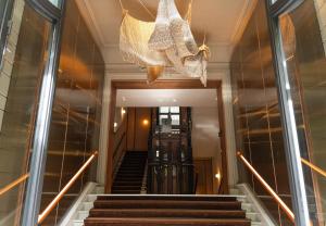 a staircase with a chandelier in a building at Mercer Madrid in Madrid