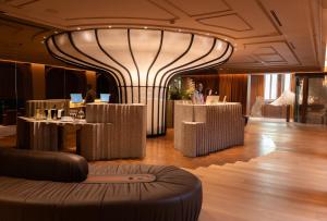 a lobby with tables and a large building at Mercer Madrid in Madrid