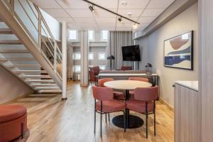a room with a table and chairs and a staircase at Scandic Grand Marina in Helsinki