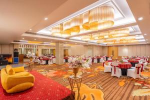 a banquet hall with red and white tables and chairs at Country Inn & Suites By Radisson Jammu in Jammu +93 photos