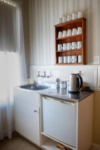 a kitchen with a sink and a counter top at The Station in Hunterville +50 photos