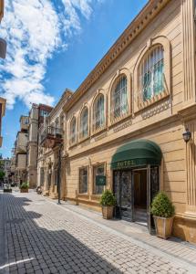 a building on the side of a street at Old Money Boutique Hotel in Baku
