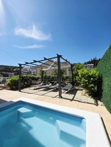 a swimming pool with a pergola and tables and chairs at Beautiful Holiday Home "Villa Relax Oasis" in Trogir +55 photos