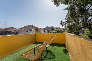 two chairs sitting on top of a balcony at GuestReady - Vanzeleres Collection in Porto