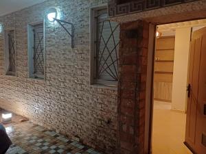 a brick wall with a window and a door at Easy Stay Agadir in Agadir +3 photos
