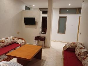 a living room with a couch and a coffee table at Easy Stay Agadir in Agadir