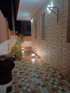 a room with a brick wall and a tile floor at Easy Stay Agadir in Agadir