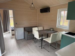 a kitchen and dining room with a table and chairs at SETO MAN Puhkekeskus in Värska