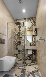 a bathroom with a shower and a toilet and a sink at Old Money Boutique Hotel in Baku +61 photos