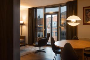 a room with a table and chairs and a large window at Radisson Blu Limfjord Hotel, Aalborg in Aalborg