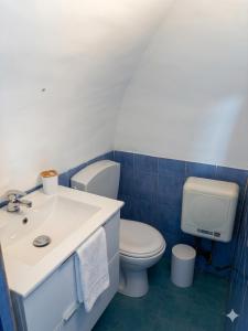 a bathroom with a toilet and a sink at Onda Blu House in Procida