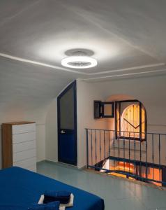 a bedroom with a blue bed and a staircase at Onda Blu House in Procida