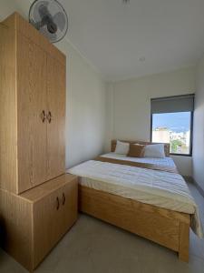 a bedroom with a bed and a large window at Morgan Hotel in Ấp Bình Hưng +27 photos