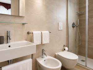 a bathroom with a sink and a toilet and a shower at Hotel Da Mario in Caorle +19 photos