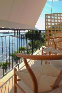 a balcony with chairs and a view of the ocean at To Nisaki in Loutraki