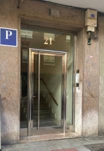 a glass door to a building with the number at Pensión el Horno REFORMADO in León +52 photos