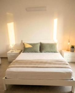 a bedroom with a large bed with two night stands at Il PuntoPiu'Alto in SantʼAntìoco