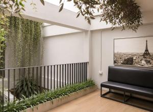 a balcony with a bench and a picture of the eiffel tower at Palmari Boutique Hotel in Ban Nua Khlong
