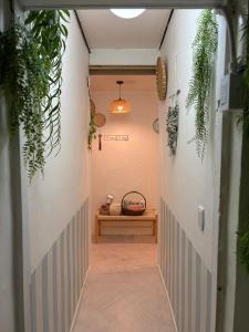 a hallway with plants and a bench in a room at Stay Everyday in Seoul