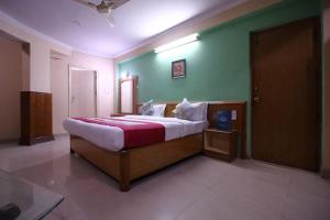 a bedroom with a large bed in a room at Hotel Sunbeam in Gwalior