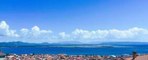 a view of a city and a large body of water at Il PuntoPiu'Alto in SantʼAntìoco +1 photo