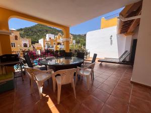 a dining room with a table and chairs on a balcony at La Manga Atalayas in Atamaría