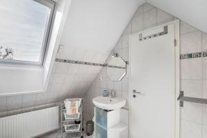 a bathroom with a sink and a mirror at Ferienwohnungen zur Eule - Steinkauz in Clausdorf +19 photos