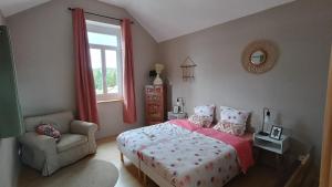 a bedroom with a bed and a chair and a window at Pierres et souvenirs in Usson-en-Forez +37 photos