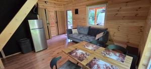 a living room with a couch and a table at Leśne Zacisze 4 in Łuka