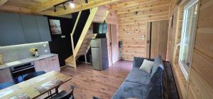a living room with a couch and a table at Leśne Zacisze 4 in Łuka +6 photos