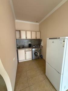 a small kitchen with a refrigerator and a stove at Hayrapetyan Apartment Goris in Goris