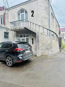 a black car parked in front of a building at Hayrapetyan Apartment Goris in Goris +3 photos
