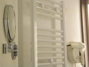 a close up of a white door with a mirror at The Originals City, Hôtel Le Gayant, Douai in Douai +13 photos