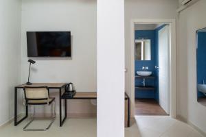 a bathroom with a desk and a sink in a room at Hotel Baia di Talamone in Talamone