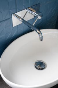 a bathroom sink with a faucet on top of it at Hotel Baia di Talamone in Talamone